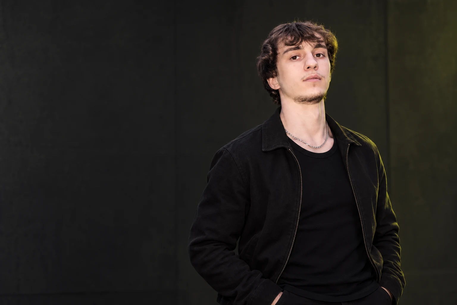 Matvey Prokudin wearing a black jacket against a dark background
